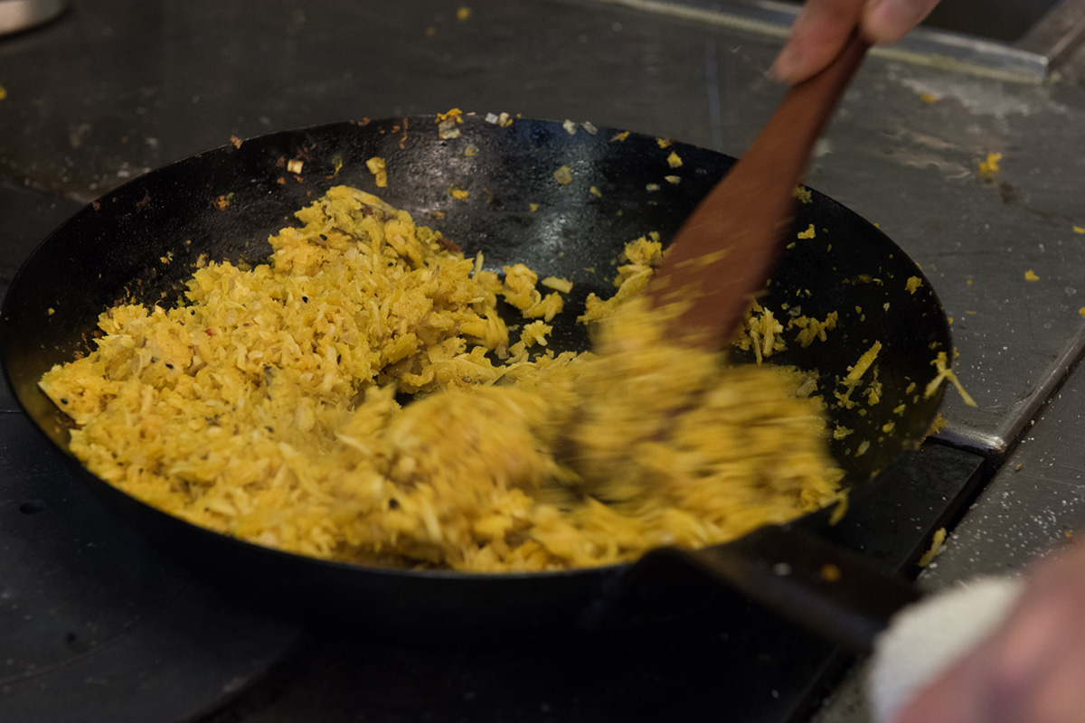Culinary student cooking rice in a wok