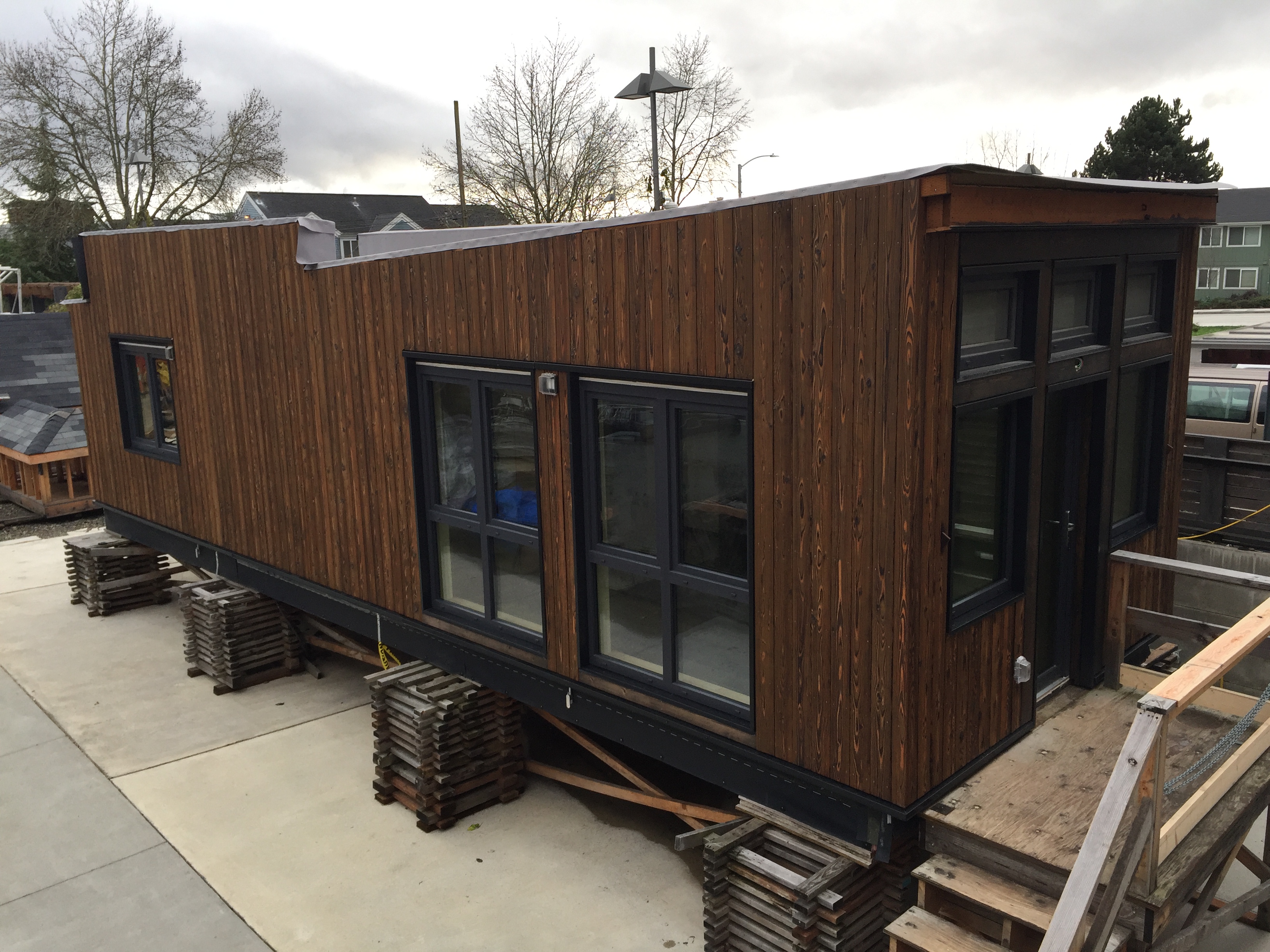 an image of the mini house on the cribbing that raises it high enough to load on a truck