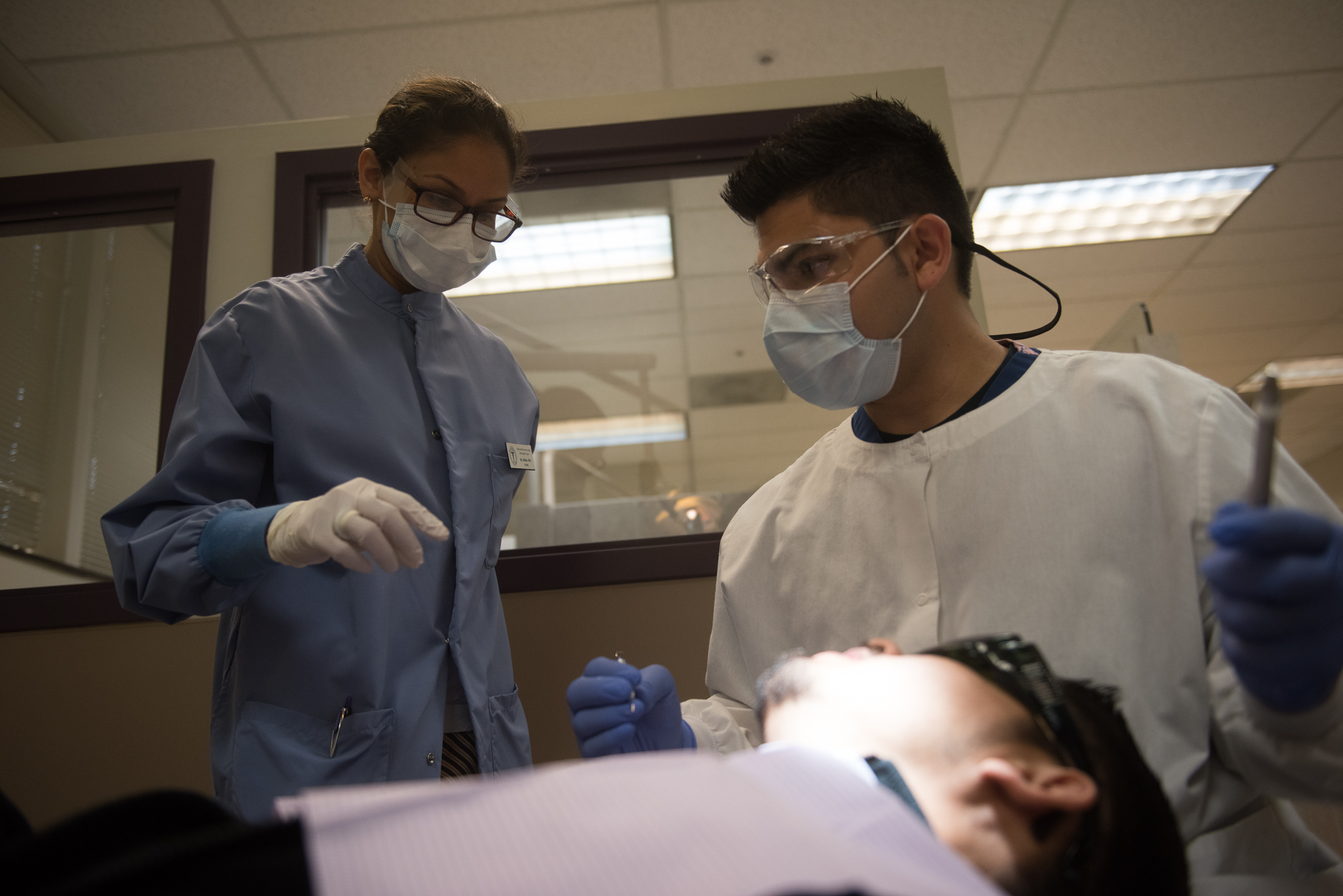 a dental student practices with a patient