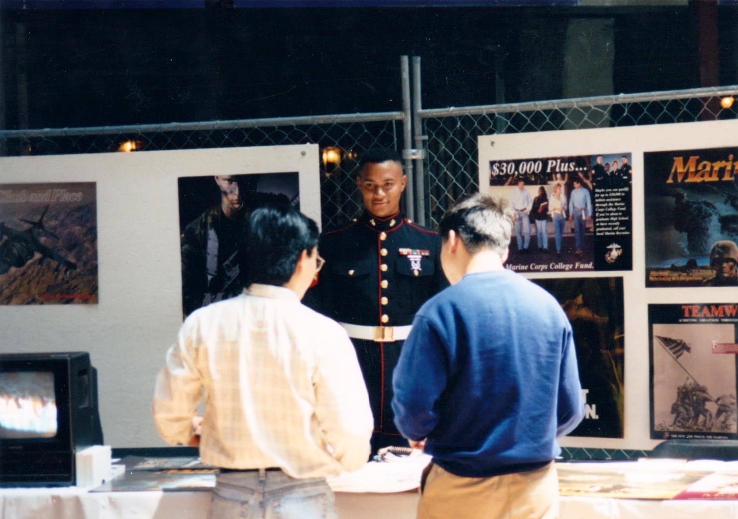 a veteral shares information with students during a fair