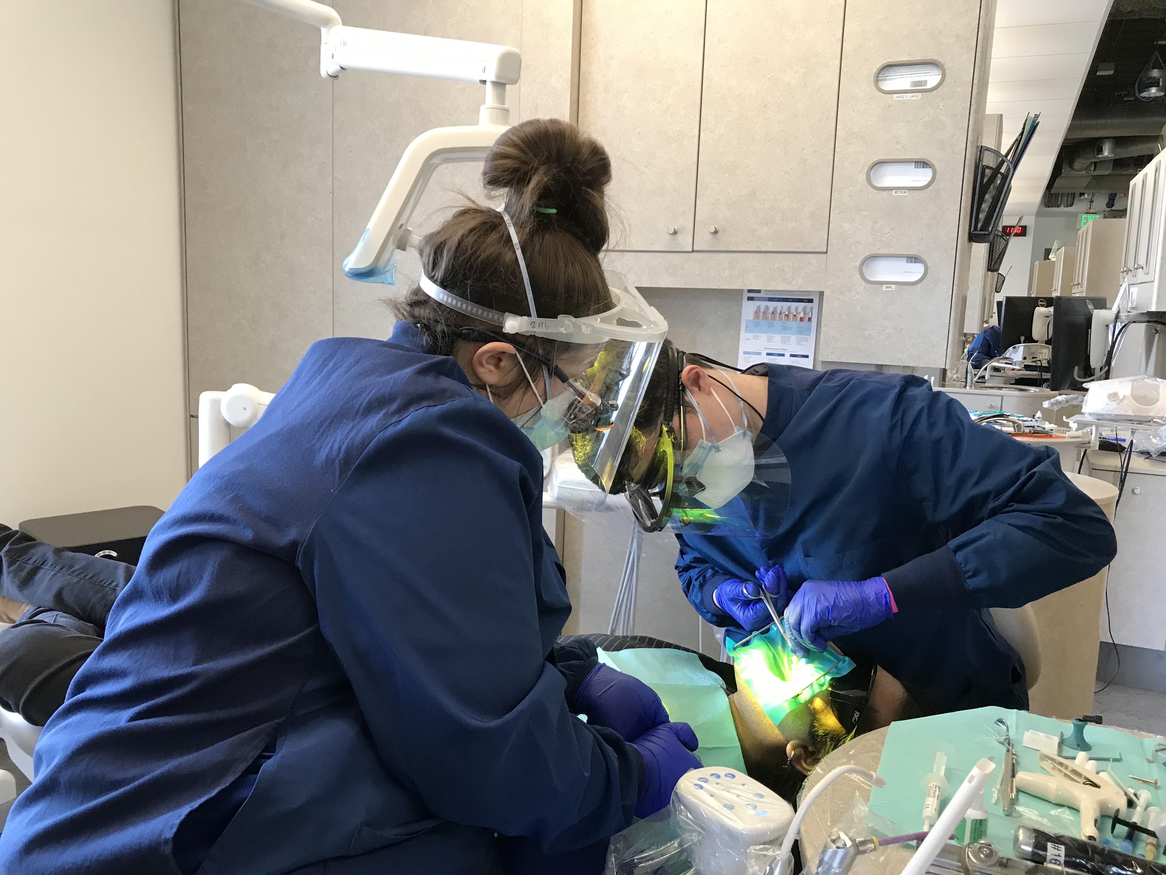 students work with a dental patient